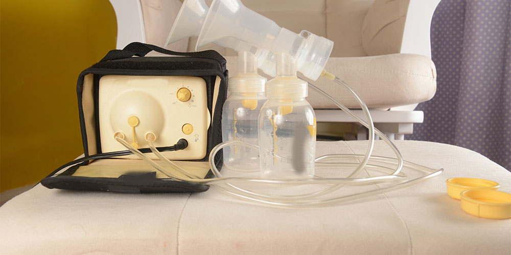 Image of a breast pump and two collection bottles sitting on a chair